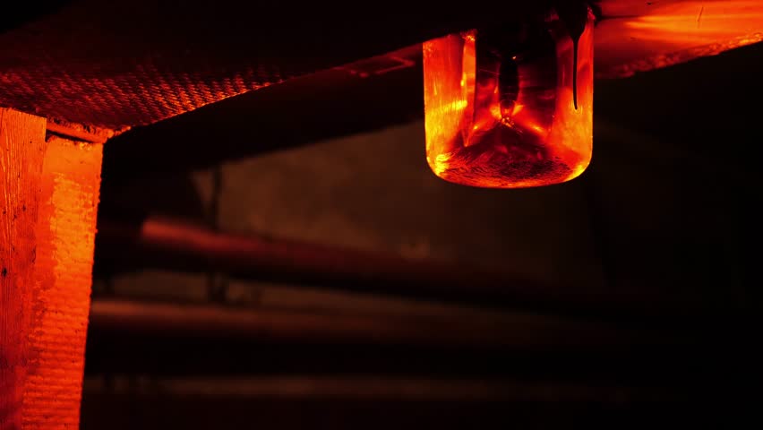 Close-up of a rotating red emergency siren lamp on the wall of a dark tunnel. A bomb shelter, an emergency signal on the wall during an air raid.