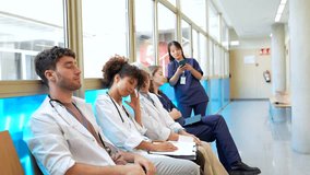 Medical professionals standing in hospital corridor, feeling tired and exhausted during momentary break between patient care shifts - Powered by Shutterstock - Get 15% off with code: PIKWIZARD15