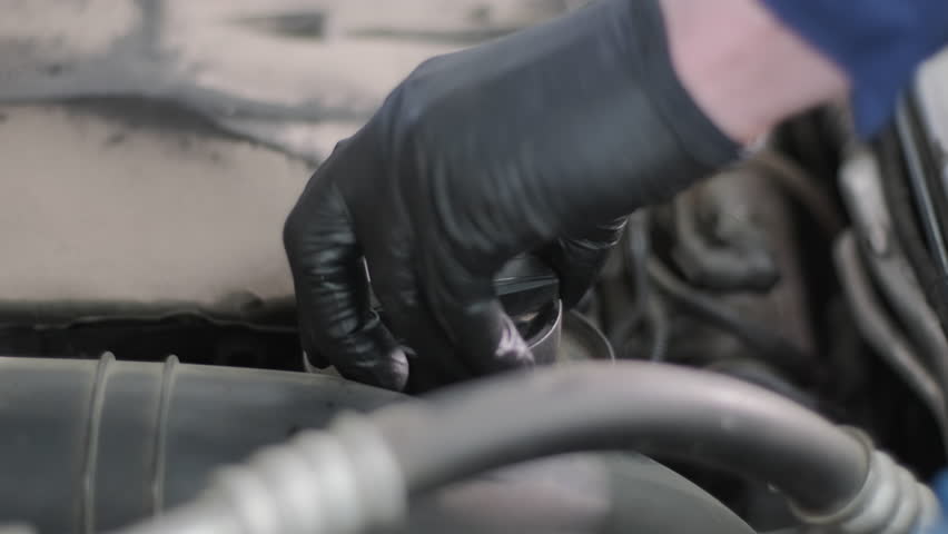 Pouring Engine Oil Into Funnel During Car Maintenance