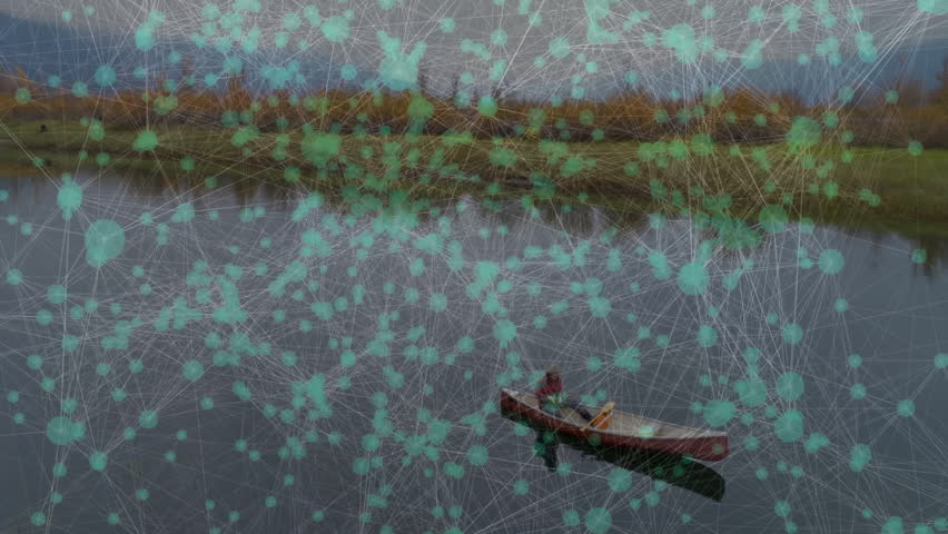 Middle-aged man dipping paddle into water canoe gliding across lake observing shoreline for travel. Adventure, serenity, wilderness, exploration, reflection, outdoor, tranquility