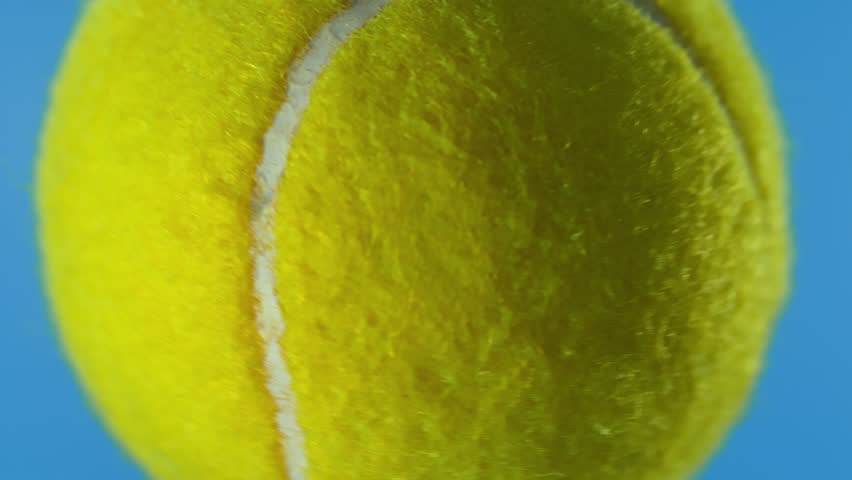 Super Slow Motion of Tennis Ball Hitting Camera on Blue Screen for Video Transition, 1000 fps.