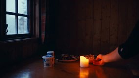 Candlelight and Plates of Pastries, Snacks, and Yogurt Create a Cozy Winter Scene in a Wooden Cabin Set in Reinsjøen, Åfjord, Trøndelag, Norway - Static Shot - Powered by Shutterstock - Get 15% off with code: PIKWIZARD15