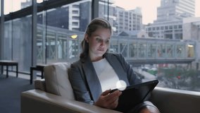 Businesswoman tapping tablet in corporate lounge starting animated network growing across cityscape. Technology, innovation, connectivity, digital, networking, modern, corporate - Powered by Shutterstock - Get 15% off with code: PIKWIZARD15