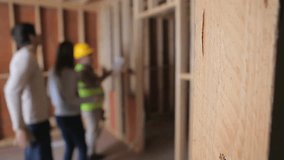 Construction AR overlay scrolling triggers builder pointing clipboard as clients inspecting framing. Architecture, renovation, smart technology, digital interface, construction site, inspection, - Powered by Shutterstock - Get 15% off with code: PIKWIZARD15