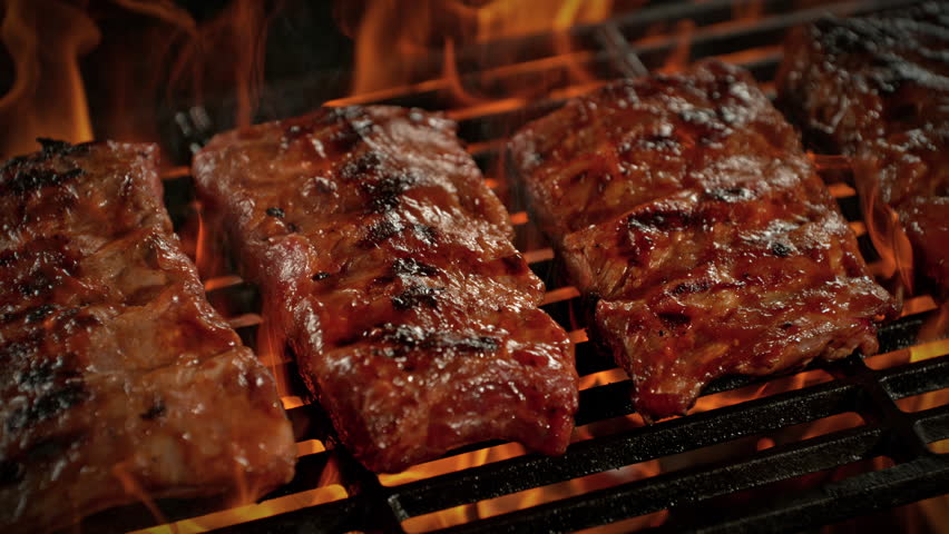 Super Slow Motion Shot of Pork Ribs on Fired Up Grill with Camera Motion at 1000fps.