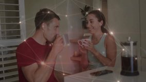Man and woman sharing coffee in kitchen, raising mugs causing tech overlay signaling emotional bond. Romance, intimacy, connection, warmth, affection, cozy, digital overlay - Powered by Shutterstock - Get 15% off with code: PIKWIZARD15