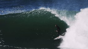 Surfer charges through foamy deep barrel with wave face churning in heavy water - Powered by Shutterstock - Get 15% off with code: PIKWIZARD15