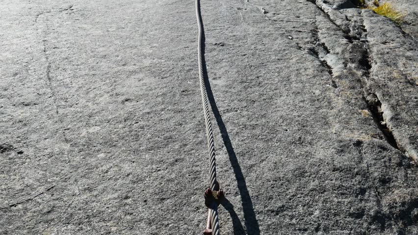 massive rock slabs with steel cable and hiker