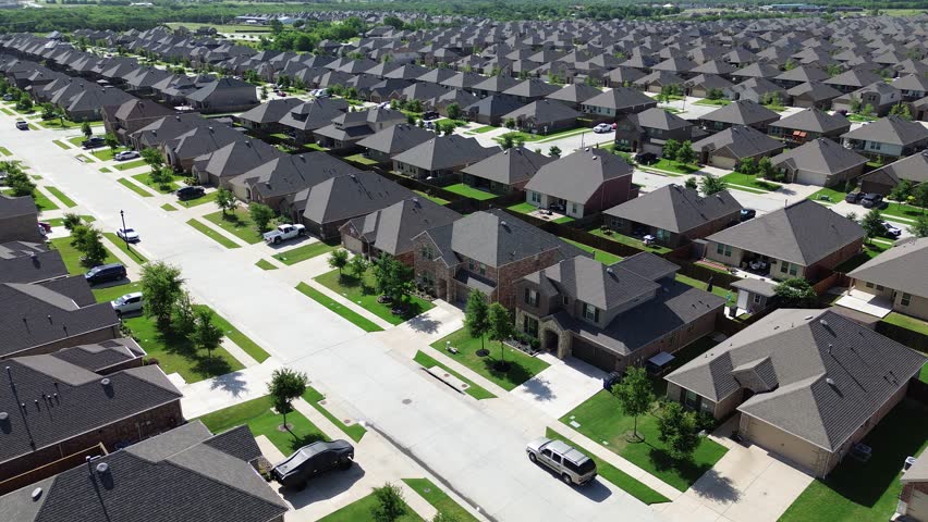 Young trees immature landscaping front yard of new construction homes, large residential street in master planned community near Beauchamp Boulevard in Princeton, Texas, two story houses, flyover. US 