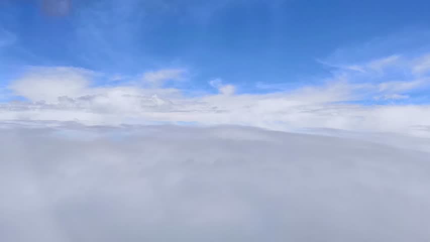 Flying right along the clouds, fading into them at the end.