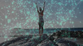 Sunrise inspiring fitness instructor practicing overhead stretch on rocky shore, pulsing overlay. Zenith, wellness, vitality, mindfulness, serenity, landscape, energetic - Powered by Shutterstock - Get 15% off with code: PIKWIZARD15