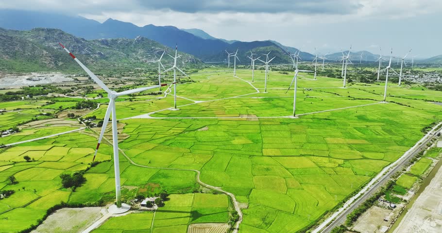 Panoramic view of wind farm or wind park. Wind turbines generating electricity on rice field at Phan Rang, Ninh Thuan, Vietnam. Clean energy concept