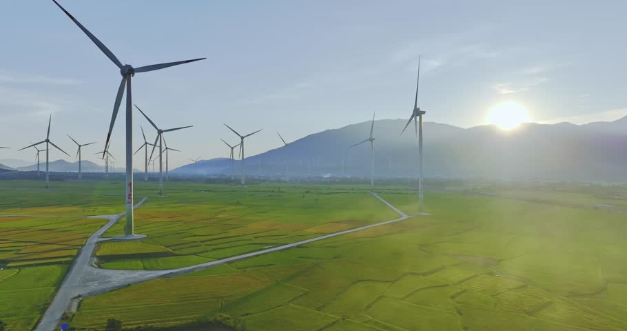 Panoramic view of wind farm or wind park. Wind turbines generating electricity on rice field at Phan Rang, Ninh Thuan, Vietnam. Clean energy concept