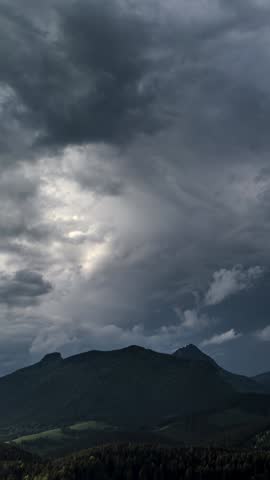 Vertical view of Storm Clouds Over Alpine Mountains in Summer Nature