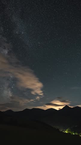 Milky Way Galaxy and Clouds Over Alps Landscape in Night Sky, Vertical Timelapse