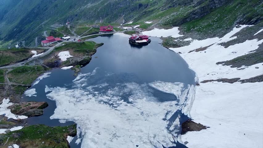 An aerial footage of the glacier lake of Balea in the Fagaras Mountains, in central Romania, near Cartisoara, Sibiu County
