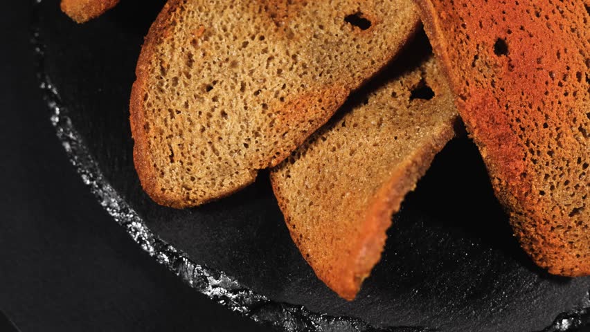 Rye bread crackers in spices on dark background, Beer snack,