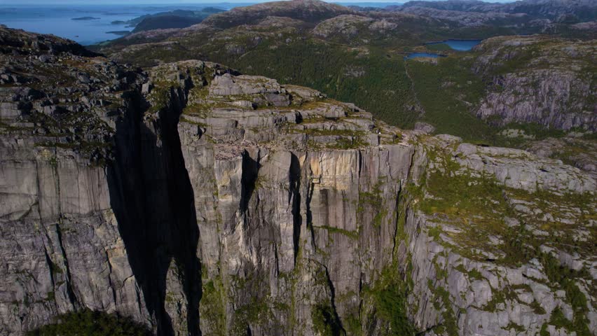 Aerial shot across Preikestolen plateau, Norway. Wide Lysefjord with mountains in the distance.