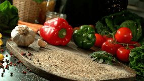 4K slow motion video of a raw salmon fillet landing on a cutting board surrounded by vegetables. Ideal for healthy food, meal prep, or seafood-themed visual content. - Powered by Shutterstock - Get 15% off with code: PIKWIZARD15