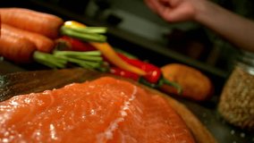 4K slow motion video of coarse salt bursting over a raw salmon fillet. Perfect for recipe prep, seafood content, and ingredient visuals in cooking or food styling projects. - Powered by Shutterstock - Get 15% off with code: PIKWIZARD15