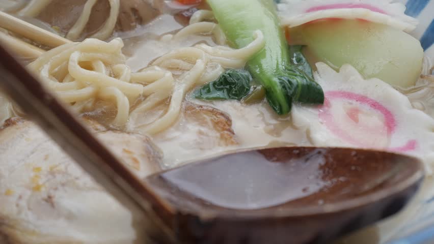 Delicious bowl of tonkotsu ramen featuring char siu pork, soft noodles, and vibrant toppings