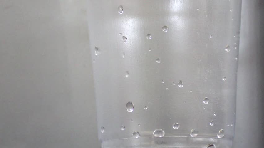 Pouring glass of water extreme closeup