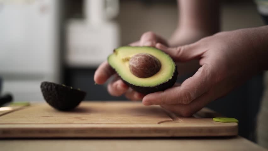 Cutting Open Fresh Avocado — Creamy and Healthy Preparation