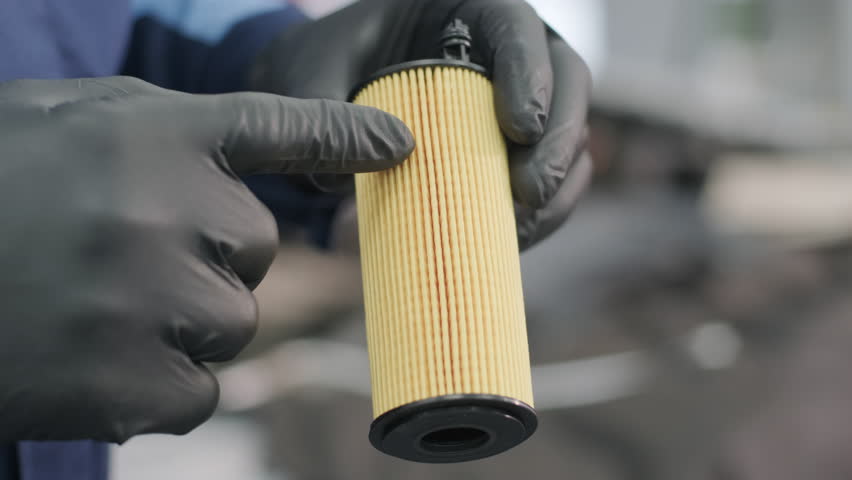 Mechanic Holding Car Oil Filter During Maintenance