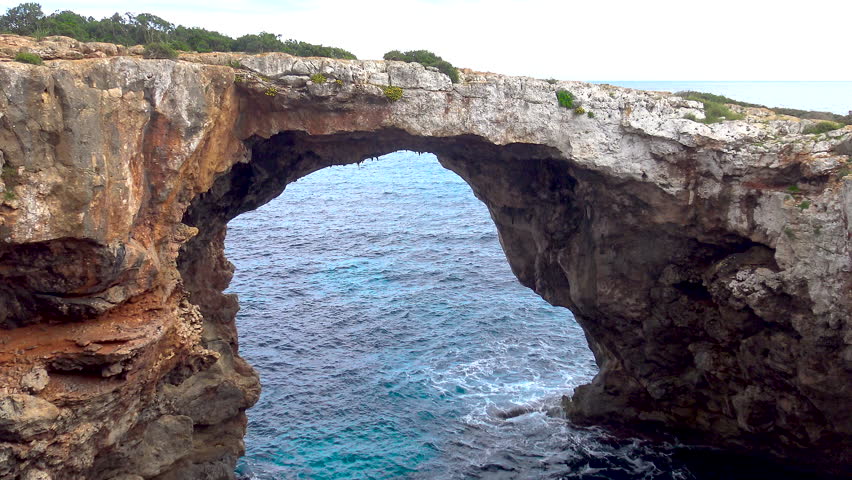 Natural rocky bridge in Cala Varques, in the West side of Mallorca Island, Spain.