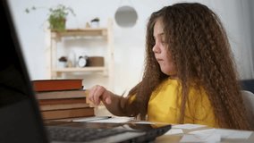 Online learn for kid using laptop. Child focused on virtual class. Young girl engaged in online education. Kid participates in remote learn. Digital learn setup for children. Online education at home. - Powered by Shutterstock - Get 15% off with code: PIKWIZARD15
