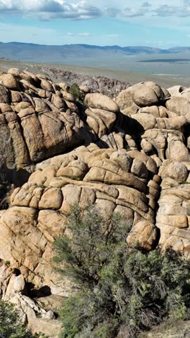 Aerial shot of interesting rock formations in the desert north of Bishop California. Vertical Video.