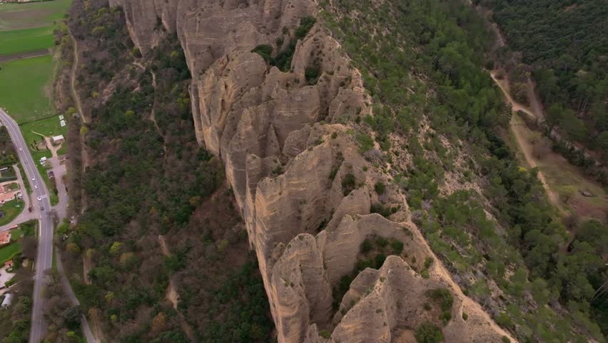 Aerial view of ancient rocks standing tall above Les Mees, France
