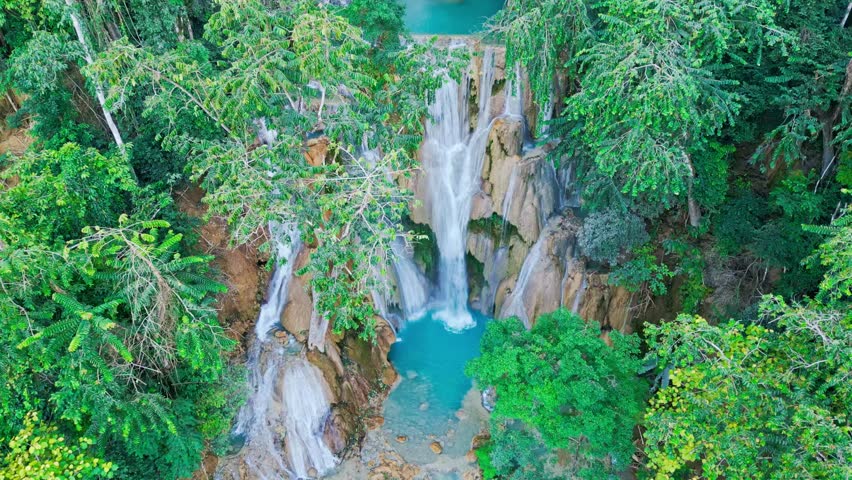 Beautiful Drone Video of Kuang Si Waterfalls in Laos, turquoise color silky waterfall in luang prabang travel video