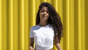 Young latin woman blowing kisses and posing in slow motion - Powered by Shutterstock - Get 15% off with code: PIKWIZARD15