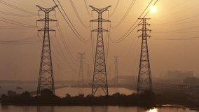 Aerial Video of High Voltage Towers and Power Line Silhouettes at Sunrise: China's Industrial Power Grid - Powered by Shutterstock - Get 15% off with code: PIKWIZARD15