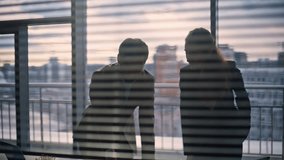 Marketing agency team silhouettes working at evening panorama cabinet closeup. Busy serious colleagues discussing business project analyzing documents. Two people doing paperwork informal atmosphere - Powered by Shutterstock - Get 15% off with code: PIKWIZARD15
