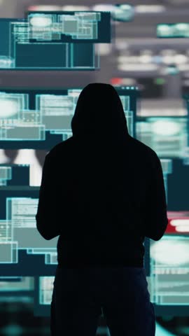 Vertical Video Male hacker breaking into a system in stealth mode by programming code, bypassing firewalls and exploiting vulnerabilities in network security to carry out cyber attack and infiltration