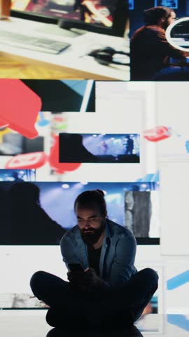 Vertical Video Young guy in misery is affected by anxiety and social depression, highlights suffering due to dangerous social media overuse. Expressive information from interaction causes distress