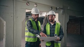 Satisfied Caucasian guys discussing draft handshake in construction contractors men technicians repairmen looking blueprint site colleagues builders architects teamwork building architecture project - Powered by Shutterstock - Get 15% off with code: PIKWIZARD15