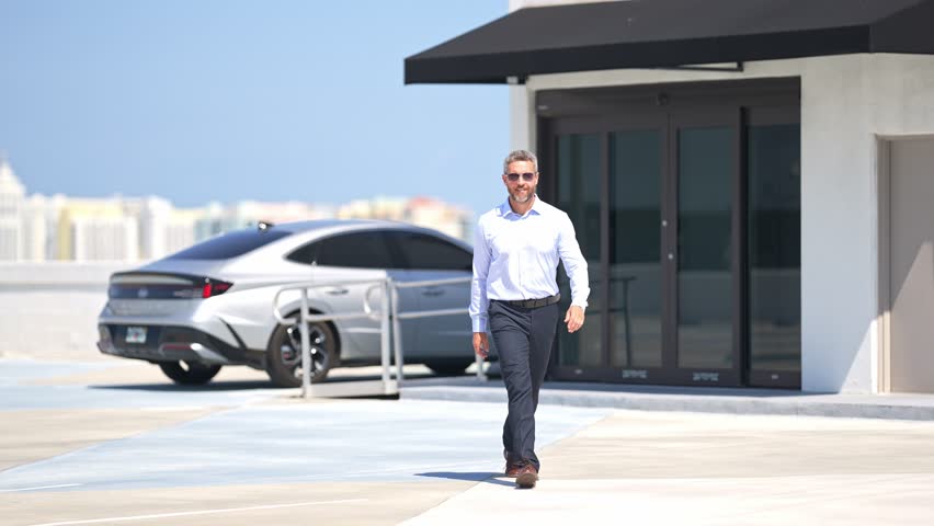 Successful businessman in shirt walk outdoors. Businessman go to office work outside. Mature businessman. Corporate business. Rich businessman in move. Outdoor business portrait. Slow motion.