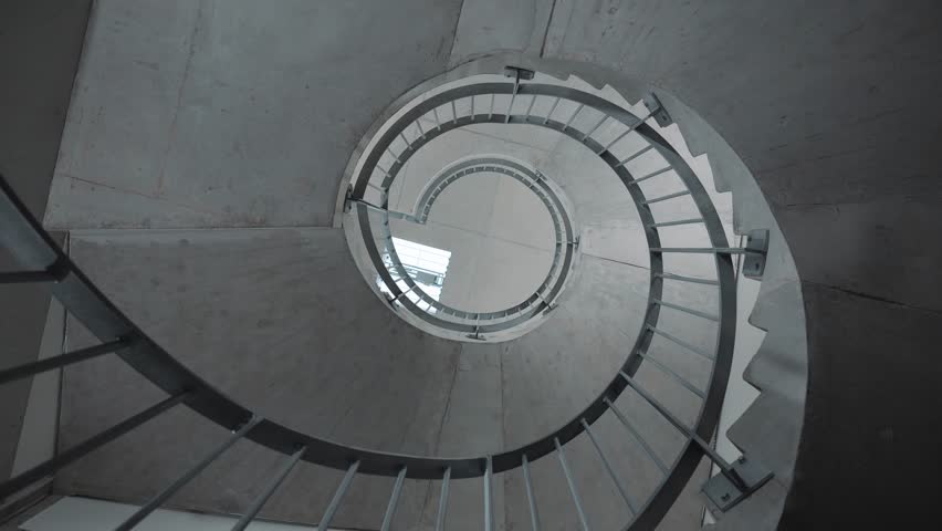 spinning shot of a beautiful stone spiral staircase within a hotel
