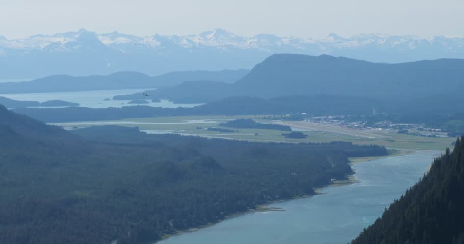 Airliner landing on Juneau airport,Alaska.Beautiful view from Mount Roberts over the Gastineau channel.