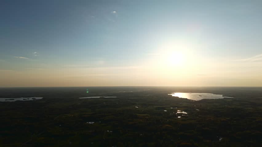 Aerial shot of expansive landscape at high altitude with sunrise light casting long shadows