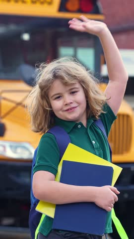 School kid waving hand near school bus. Child go to school bus. American education scene. School moment. USA childhood memory. Learning today. Child with sook and backpack ready to lesson.