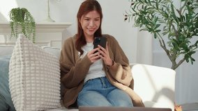 Young asian woman using smartphone to chat with AI chatbot in living room at home, communication and technology, female browsing chatbot on smart phone enjoying artificial intelligence with cozy. - Powered by Shutterstock - Get 15% off with code: PIKWIZARD15
