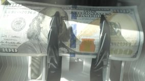 Close up cash counting machine counting money. Banknotes of 100 dollar bills. Money count machine, investment banking, cash transaction concept. Finance, currency and crisis recession. - Powered by Shutterstock - Get 15% off with code: PIKWIZARD15