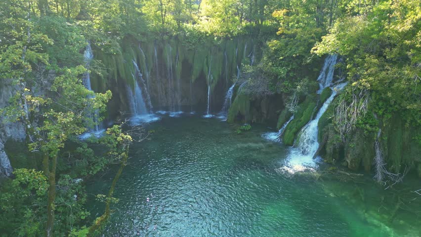 Beauty nature with waterfall. Panoramic aerial view of waterfalls. Beauty green nature. Plitvice lakes and Waterfall. Beauty waterfall landscape in Croatia. Crystal-clear water in Plitvice.