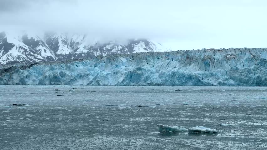 Explore the serene beauty of Hubbard Glacier in Glacier Bay, Alaska. The mesmerizing icy landscape reveals the majesty of nature, with icebergs floating in the calm waters.