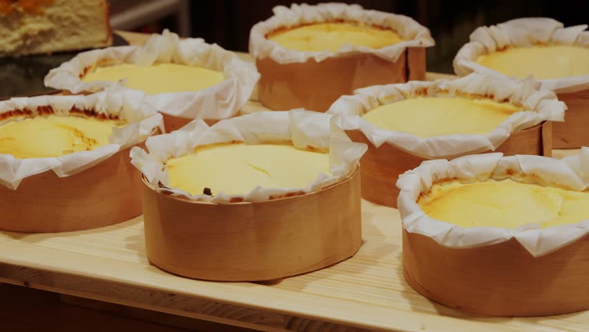 Cheesecakes in a pastry shop window. Delicious San Sebastian pastries in a cafe display.