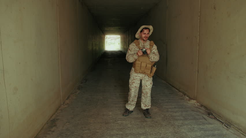 Soldier With A Camera Shooting Photos At The End Of The Tunnel